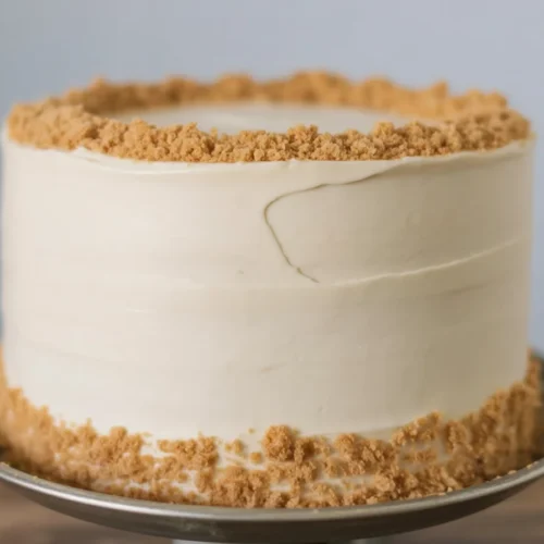 A beautifully decorated Thanksgiving cake featuring fall leaves and seasonal flavors.