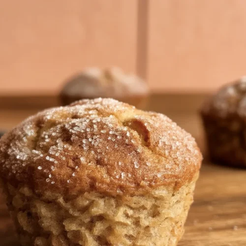 Delicious apple cider donut muffins coated in cinnamon sugar, perfect for fall.